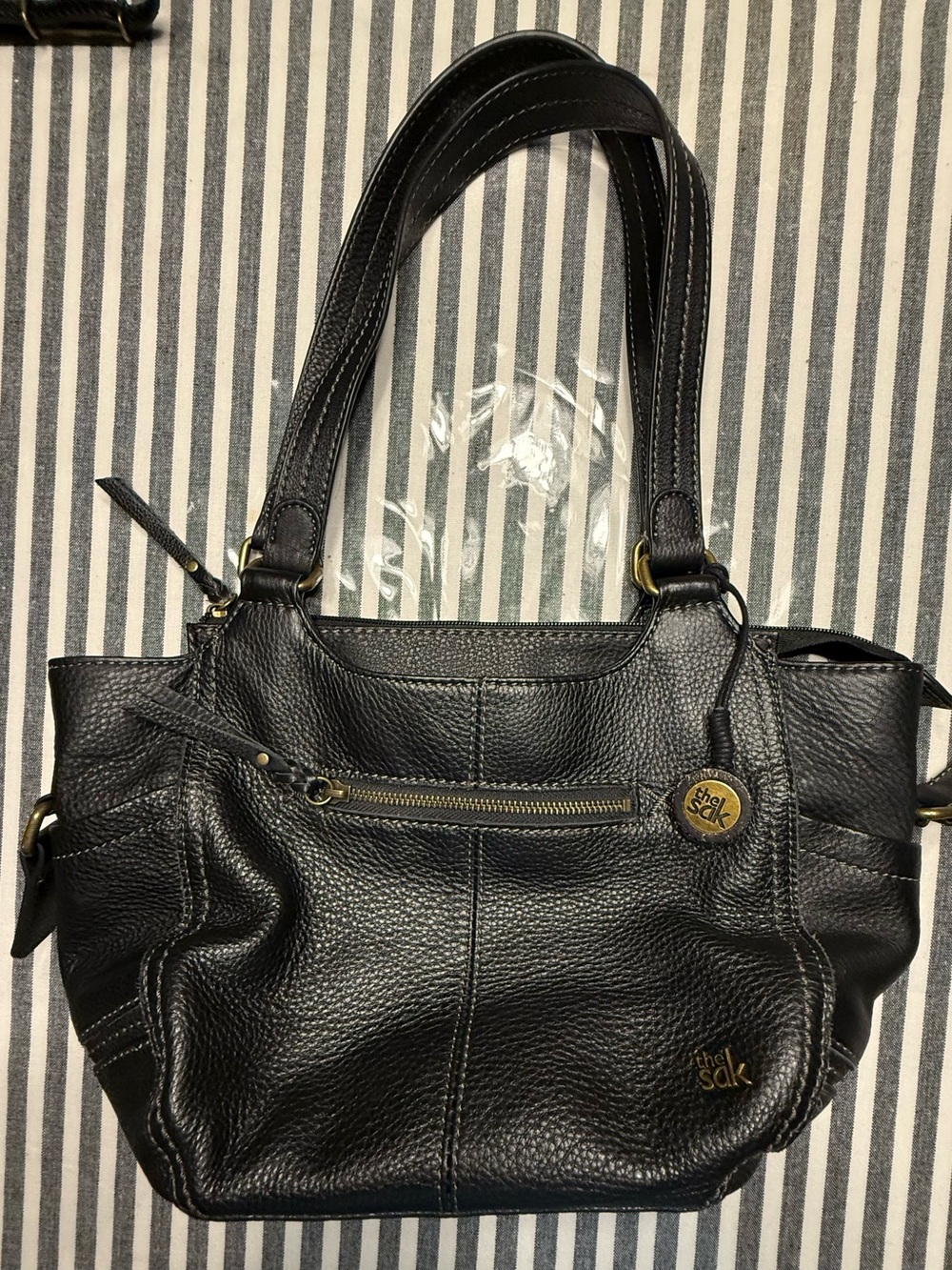 The Sak Black Pebbled Leather Shoulder Bag with Brass Accents